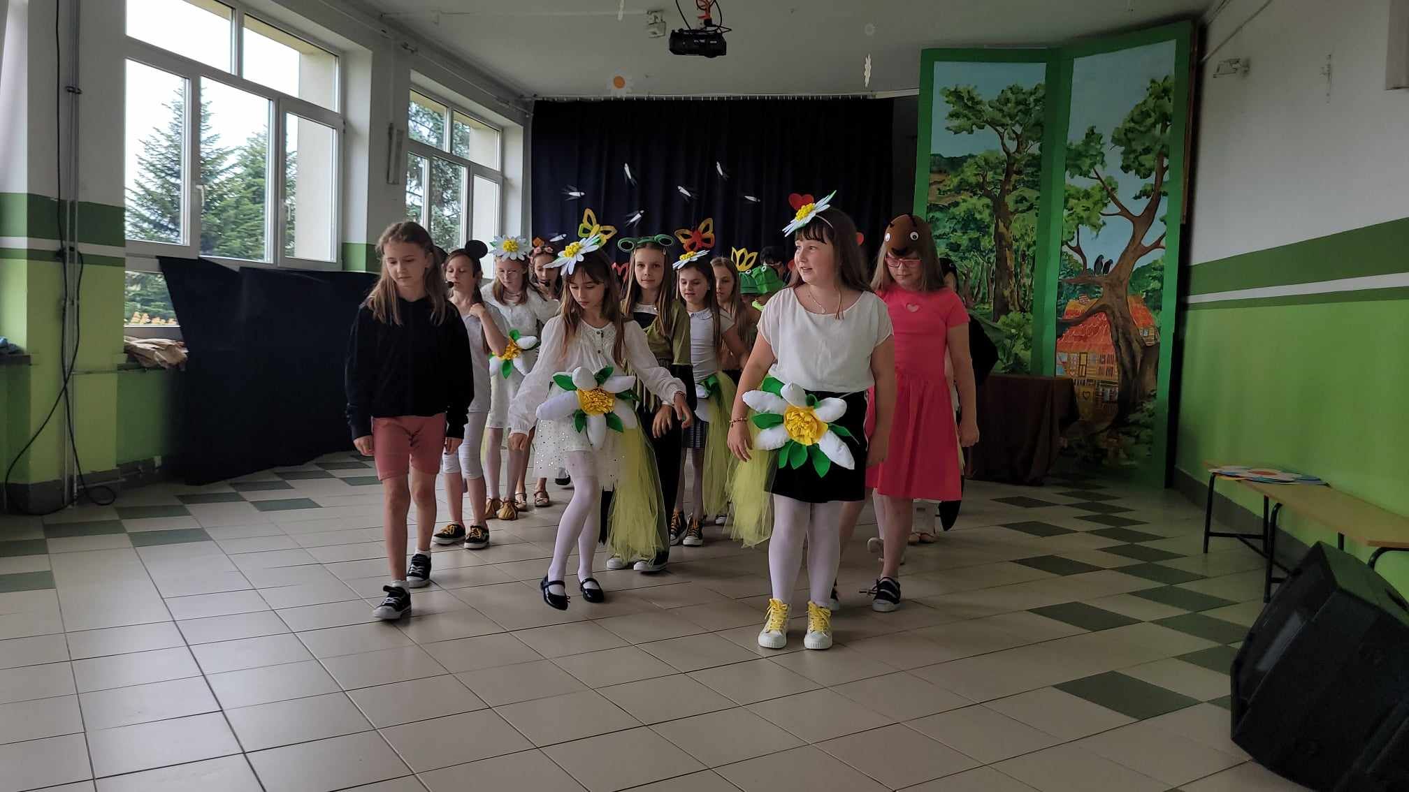 Dzieci podczas występu teatralnego w strojach scenicznych.